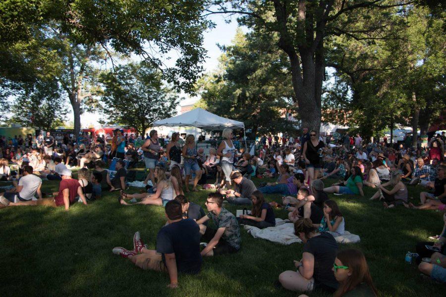 Crowds sit on the grass between acts at Taste of Fort Collins 2017 (Chapman Croskell | Collegian)