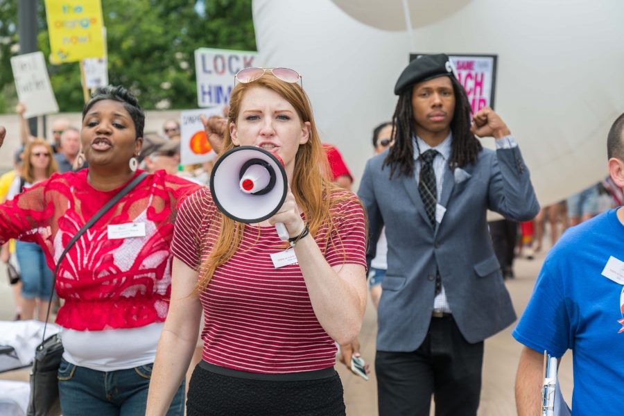 Samantha Montgomery, one of the Trump Impeachment March organizers, leads the protesters around the Colorado State Capitol. (Davis Bonner | Collegian)