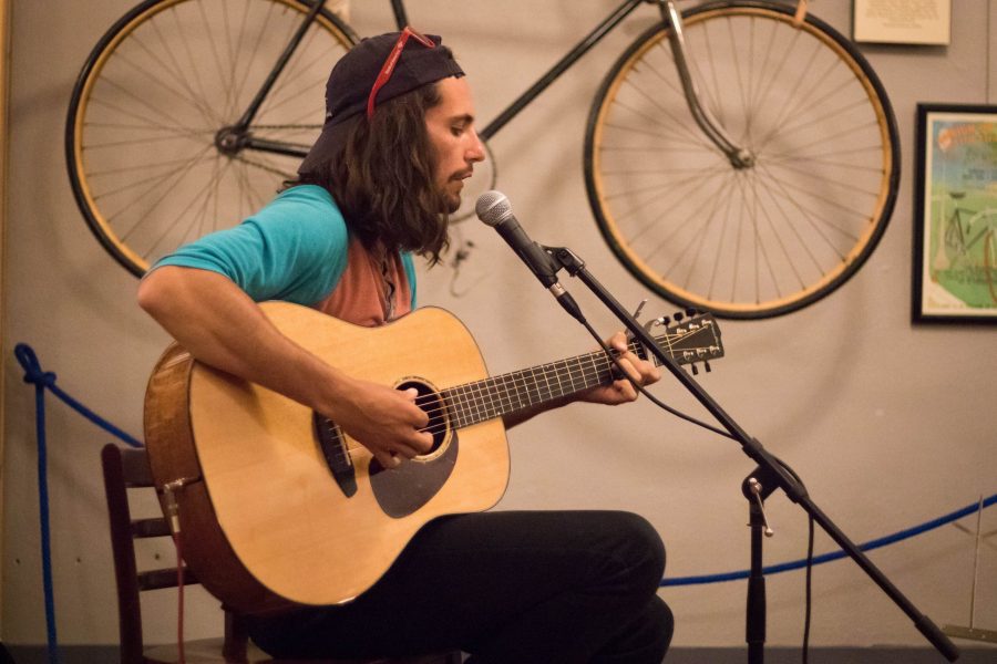 Justin Youngk, CSU graduate and host for the open mic event at the Bean Cycle, performs an original song at the I AM Open Mic event (Julia Trowbridge | Collegian)