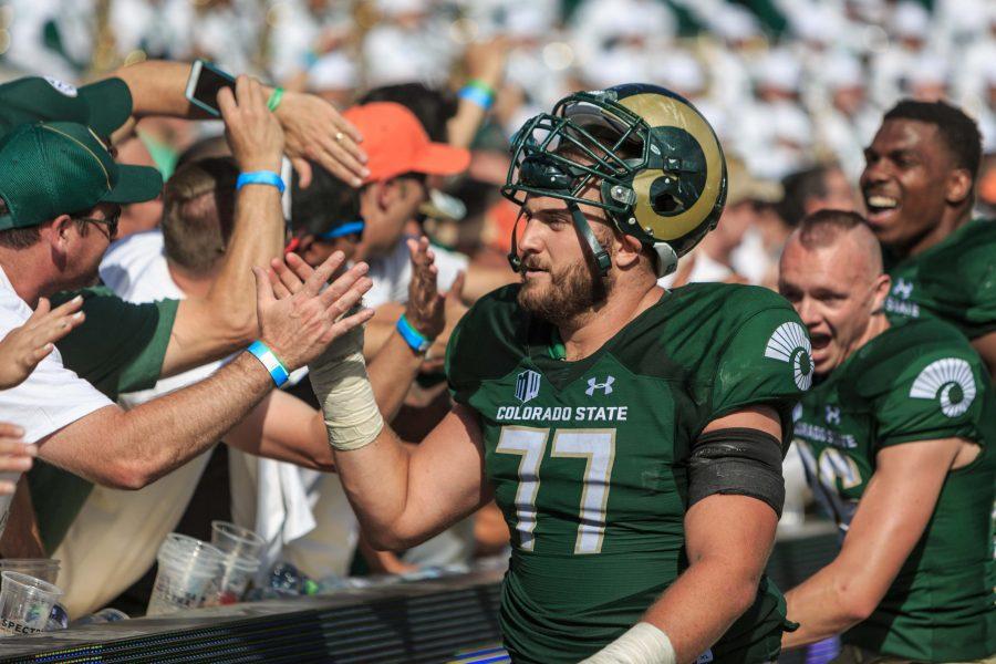 Starting center Jake Bennett celebrates a victory with fans after crushing Oregon State 58-27 in the first game played at the on-campus stadium. (Davis Bonner | Collegian