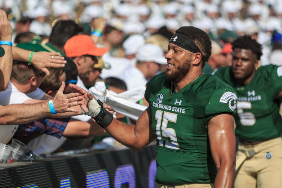 CSU linebacker Kiel Robinson celebrates the team's victory with fans after crushing Oregon State 58-27. (Davis Bonner | Collegian