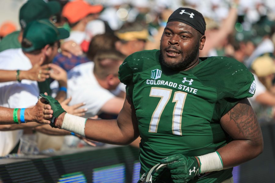 CSU offensive lineman Jeff Taylor celebrates the team's victory with fans after crushing Oregon State 58-27. (Davis Bonner | Collegian