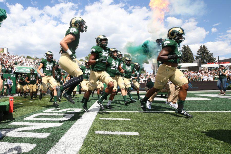 The CSU Football Team runs out to the New On-campus Stadium on August 26, 2017. The Rams were welcomed to the field by a sold out crowd. (Elliott Jerge | Collegian)
