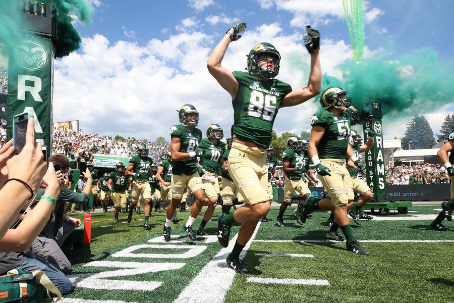 The CSU Football Team runs out to the New On-campus Stadium on August 26, 2017. The Rams were welcomed to the field by a sold out crowd. (Elliott Jerge | Collegian)