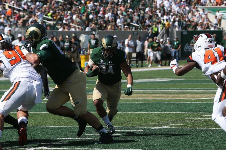 Colorado State Running Back Izzy Mathews finds the hole in the OSU defense. The Rams are playing their Inaugural Game at the New On-Campus Stadium. (Elliott Jerge | Collegian)
