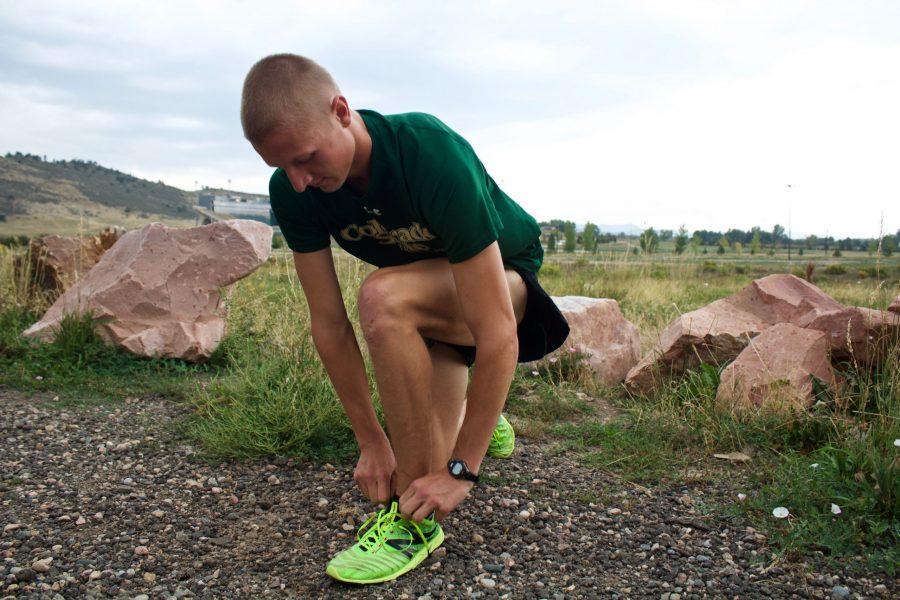Junior Civil Engineer and Cross Country/Track athlete Trent Powell performs a pre-race tradition of spiking up and doing a few strides before the CSU home Cross Country meet at Hughes Stadium on September 1st. (Matt Begeman | Collegian)