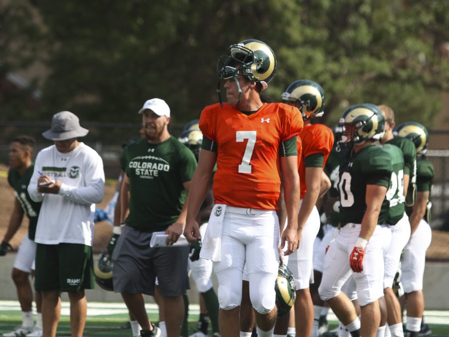 Senior Quarterback Nick Stevens (7) takes a break to the sideline Head Coach Mike Bobo shows some intensity and emotion during one of the CSU Football drills on August 1st at the new CSU stadium practice field. (Javon Harris | Collegian)