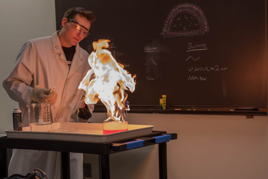 Justin Brookhart, Demo Specalist for the Chemistry Club, lights butane bubbles on fire during one of the club meetings (Julia Trowbridge | Collegian)