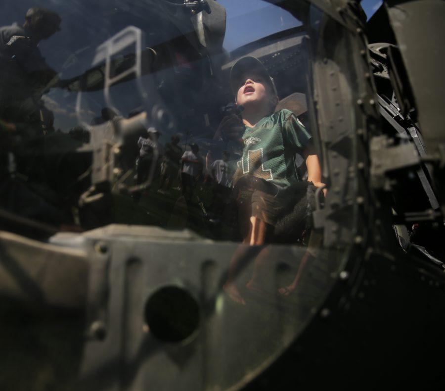 Camden McElroy checks out a UH-60 Black Hawk helicopter being displayed on the Intramural sports fields at Colorado State University before the start of the first football game of the 2017 season on Saturday, August 26th. Forrest Czarnecki | The Collegian