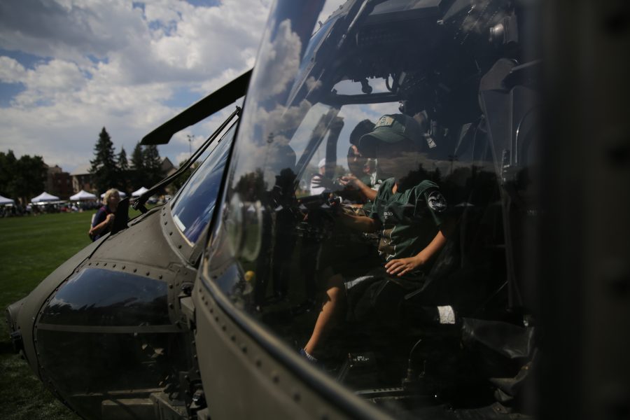 Camden McElroy checks out a UH-60 Black Hawk helicopter being displayed on the Intramural sports fields at Colorado State University before the start of the first football game of the 2017 season on Saturday, August 26th. Forrest Czarnecki | The Collegian