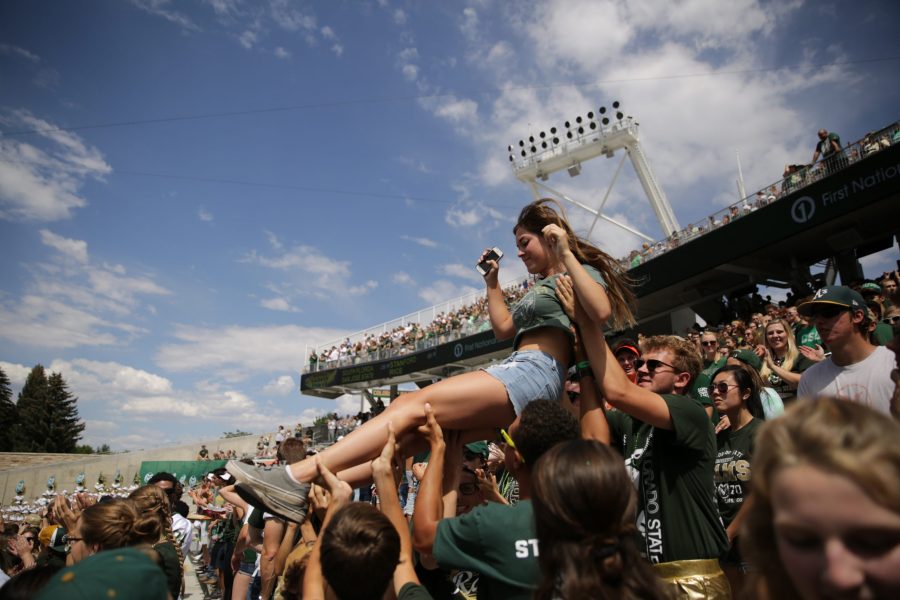 Colorado State University sophomore Paris Smouse is lifted up in the air by other fans to celebrate a CSU touchdown during the Rams first football game of the season on Saturday, Aug. 26. (Forrest Czarnecki | The Collegian)