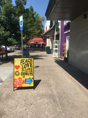 an outsider's view of what the sign looks like right outside the donut shop in old town