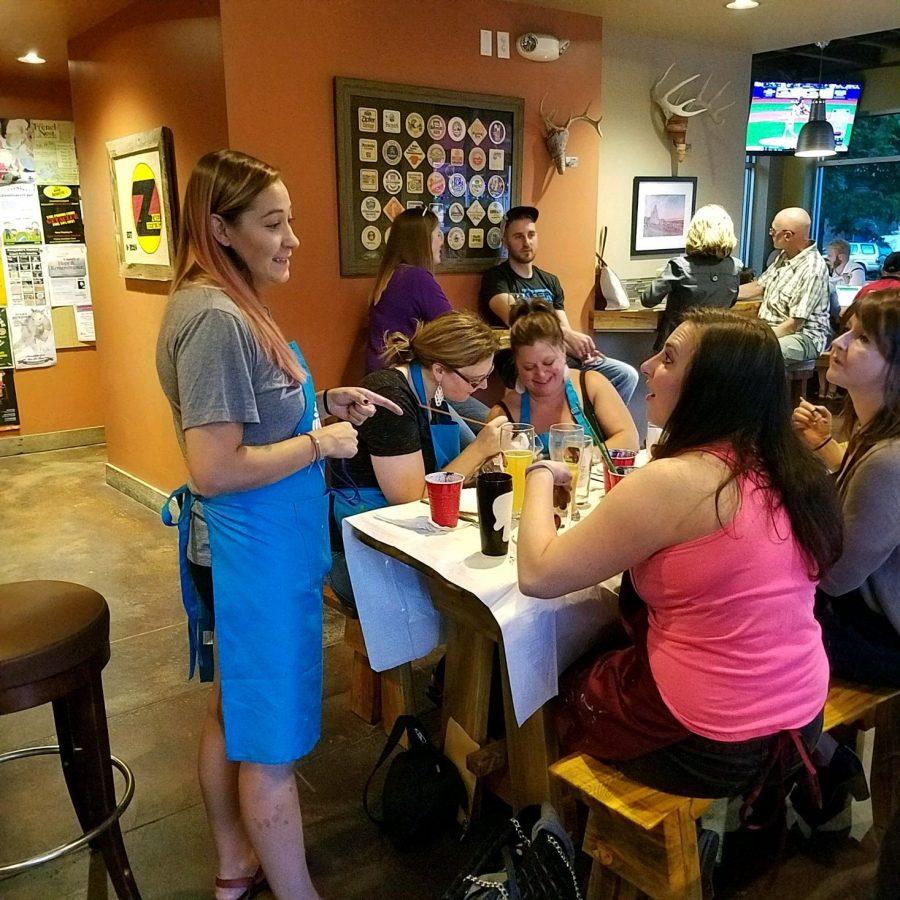 Chelsea Ermer chats with participants of the Pinots Palette Paint a Pint night. Photo credit: Casey Setash