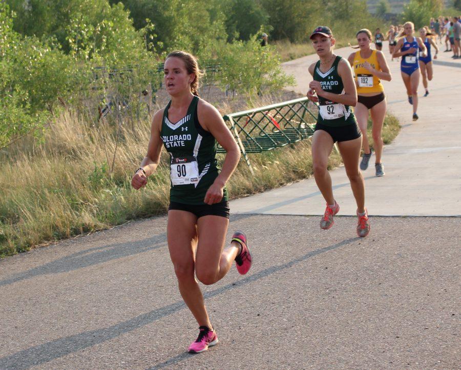 Juniors Ali Kallner (90), finishing in 13th place, and McKenna Spillar (92), finishing in 10th place, run in a cross country meet at Hughes Stadium on Friday, Sept. 1, 2017. (Jenny Lee | Collegian)