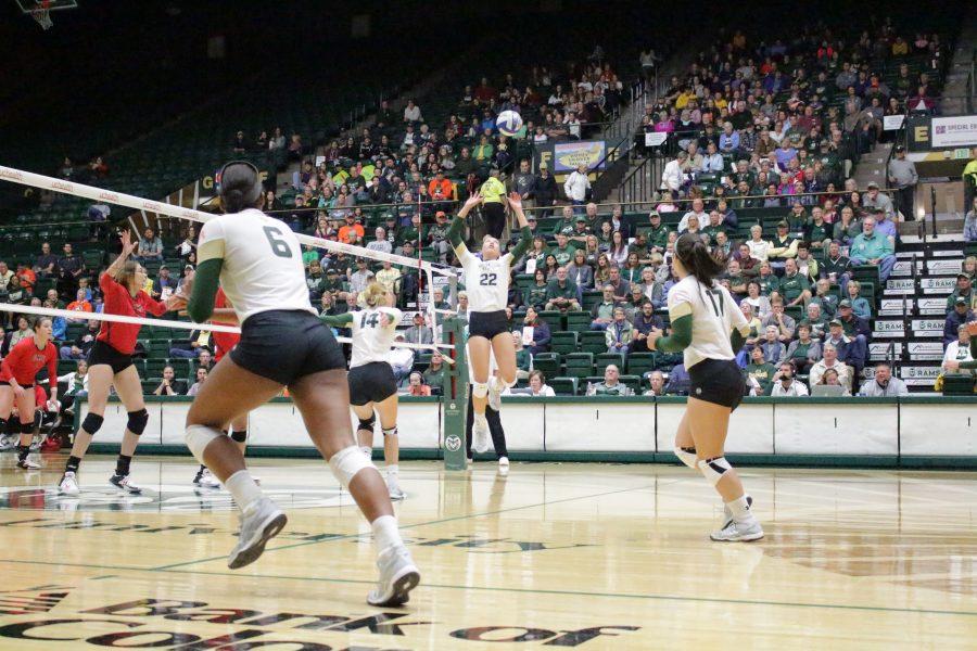 Sophomore Katie Oleksak (22) sets the ball at the CSU vs. UNLV volleyball match in Moby Arena on Sept 23. (Jenny Lee | Collegian)
