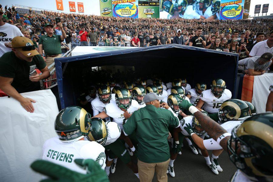 The Colorado State football team gets hyped up in the tunnel at Mile High Stadium prior to the Rocky Mountain Showdown Kick Off. (Elliott Jerge | Collegian)