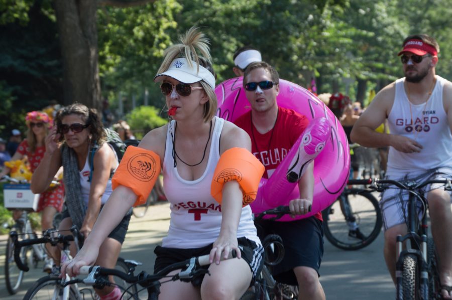 A group of life guards are prepared for safety as they ride through the Tour de Fat parade Saturday afternoon. Photo by Olive Ancell | Collegian