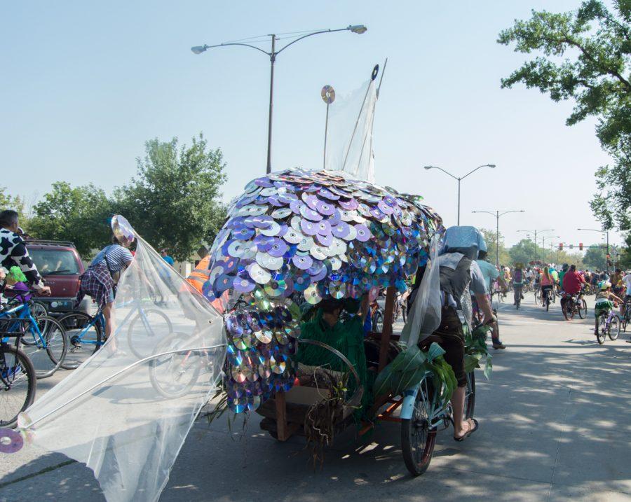 This giant fish was made out of CDs, tinfoil, mesh and plants. It glistened while swimming in the crowd for Tour de Fat Saturday Afternoon. Photo by Olive Ancell | Collegian