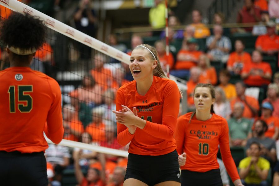 Senior Alexandra Poletto (middle) celebrates a point against the University of Michigan on Sept. 8. The Rams defeated the Wolverines in three sets. (Elliott Jerge | Collegian)