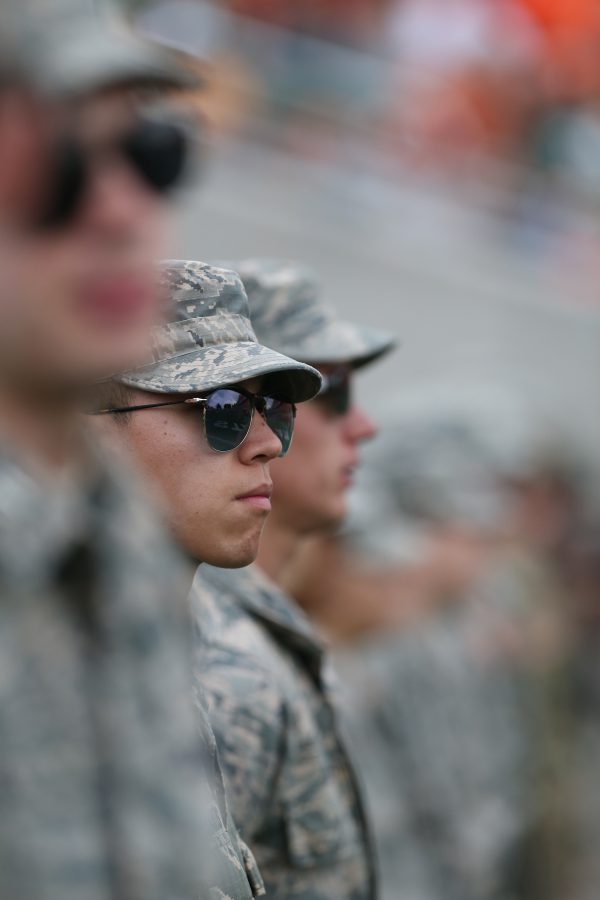 An ROTC member looks out onto Sunny Lubrick Field on Sept 8 during a game against Abilene Christian. The Rams are ahead of the Wildcats 31-10 at the end of the third quarter. (Elliott Jerge | Collegian)