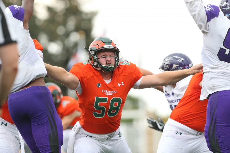 Long Snapper Trent Sieg blocks the Abilene Christian defense during an extra point attempt. The Rams are ahead of the Wildcats 31-10 at the end of the third quarter on Sept. 8, 2017. (Elliott Jerge | Collegian)
