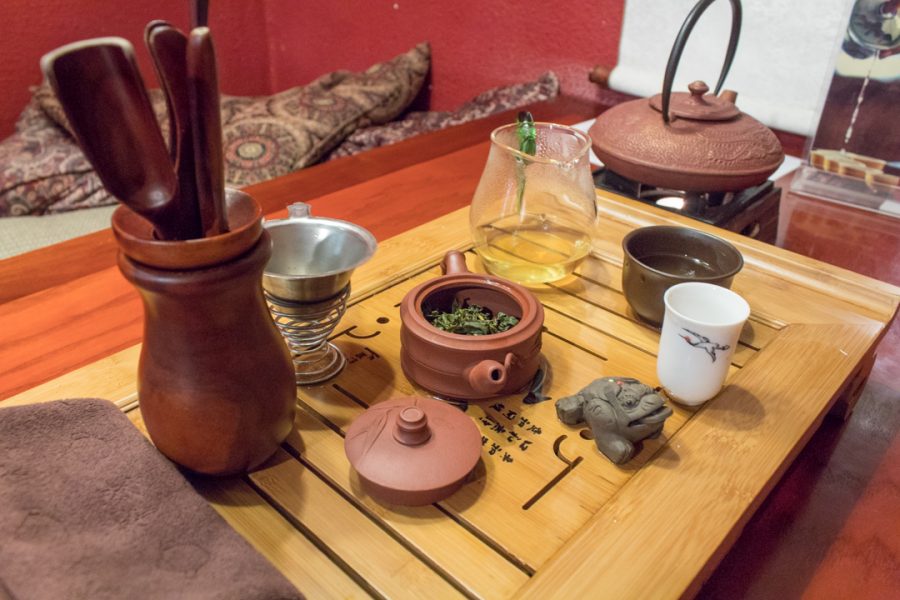 A Gong fu tray displays utensils and tools to prepare a warm silk oolong green tea, Monday, Sept. 25, 2017, in Ku Cha Tea House, Fort Collins, Colorado. A tea mastered prepared tea leaves using Chadao tools directly imported from China in a traditional setting snuggled between two cushions and a low legged table. Tyler Morales | Collegian