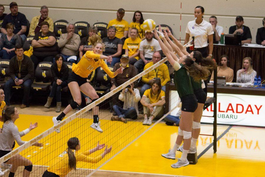 Blockers Paulina Houggard-Jensen and Katie Oleksak block a hit from a Wyoming player during the game on Sept. 26. The Rams swept the Cowgirls in three sets. (Ashley Potts | Collegian)