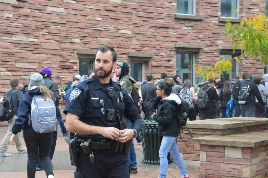 Policemen give the go-ahead for students and staff to go back into Morgan Library after having to evacuate Wednesday. The fire alarms in the library went off, forcing people to evacuate for about 30 minutes.