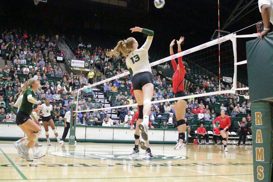 Sophomore Kirstie Hillyer (13) spikes the ball at against UNLV in Moby Arena on Sept 23. (Jenny Lee | Collegian)