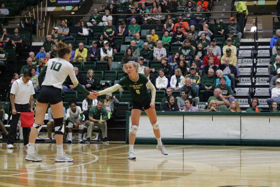 Sophomore Amanda Young (8) and senior Sanja Cizmic (10) low-five before a game begins at the CSU vs. UNLV volleyball match in Moby Arena on Sept 23. (Jenny Lee | Collegian)