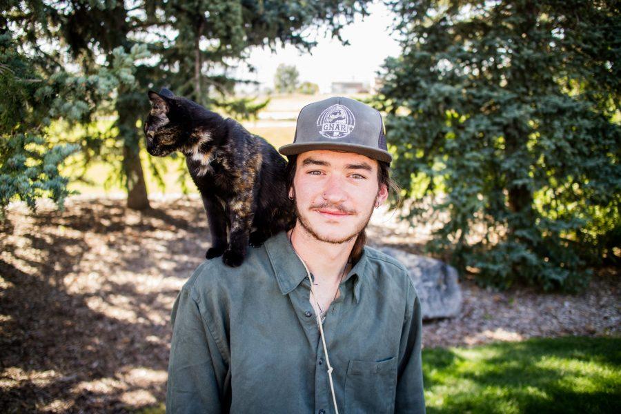 Cole McCullough and his 6-month old cat Sequoia pose for a photo, Sequoia goes hiking with McCullough and rides on his shoulder. (Tony Villalobos | Collegian)
