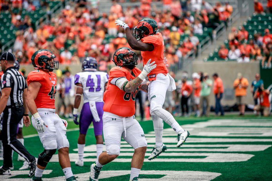 CSU running back Dalyn Dawkins celebrates his first touchdown of the game with offensive lineman Trae Moxley. (Davis Bonner | Collegian)