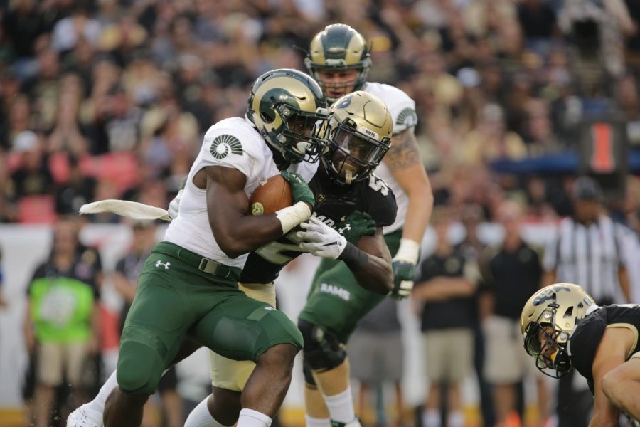 Running back Rashaad Boddie stiff arms a CU defender during the Rocky Mountain Showdown. (Forrest Czarnecki | Collegian)