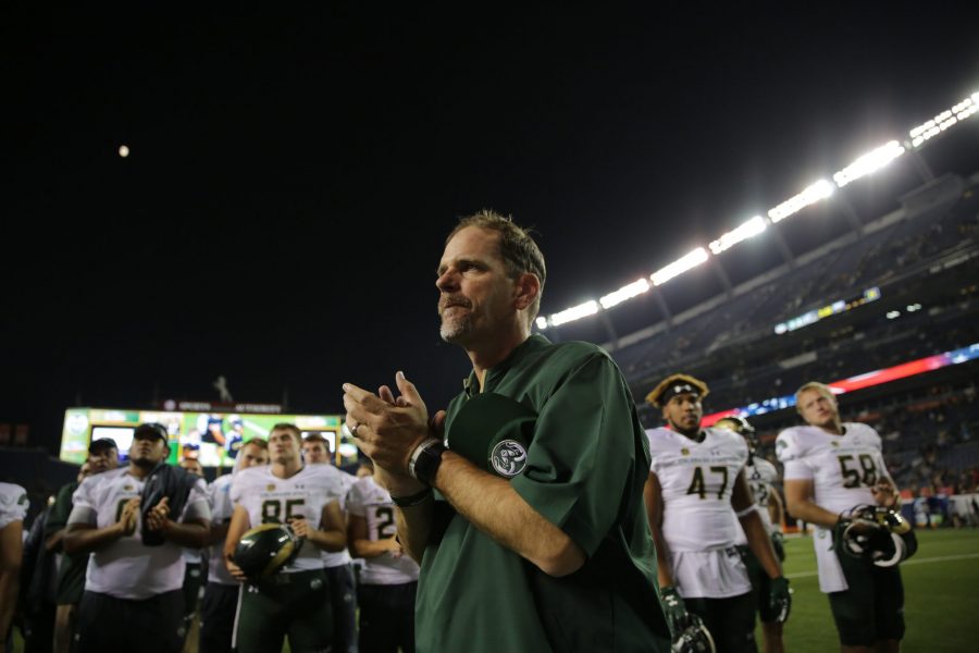 Colorado State University head coach Mike Bobo helps lead his team while the team sings to CSU fans after the game on Friday night. (Forrest Czarnecki | Collegian) 
