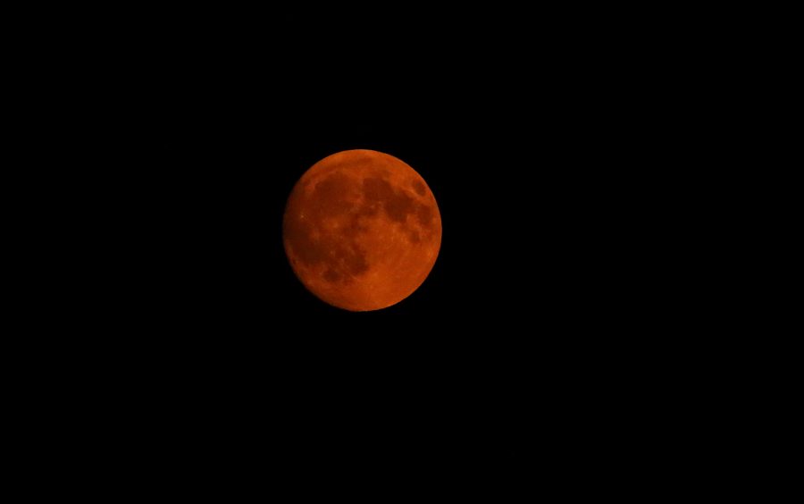 The moon is painted a deep red as it rises over Fort Collins on Monday, September 4th. The moon has such a deep red tint to it due to atmospheric haze caused by wildfire smoke and dust particulates. (Forrest Czarnecki | Collegian)