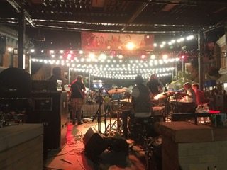 a backstage view of a band performing at Fortoberfest. 