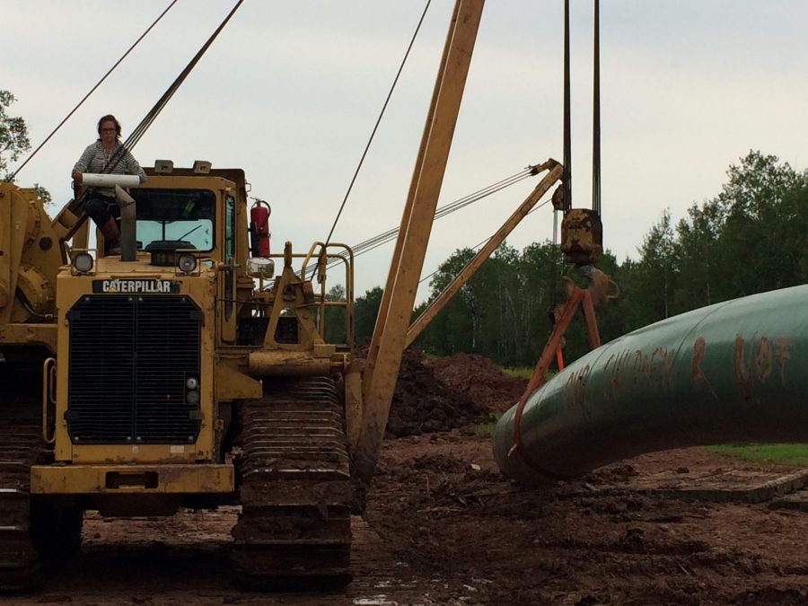 A Water Protector Locked Down to Heavy Equipment At Site of Line 3 - Wisconsin. (Cullen Lobe | Collegian)