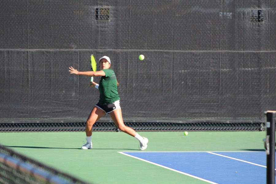Sophomore Alyssa Grijalva positions herself to send a shot back to her opponents during her doubles match at the Jon Messick Invitational on Oct 8. (Joshua Contreras | Collegian)