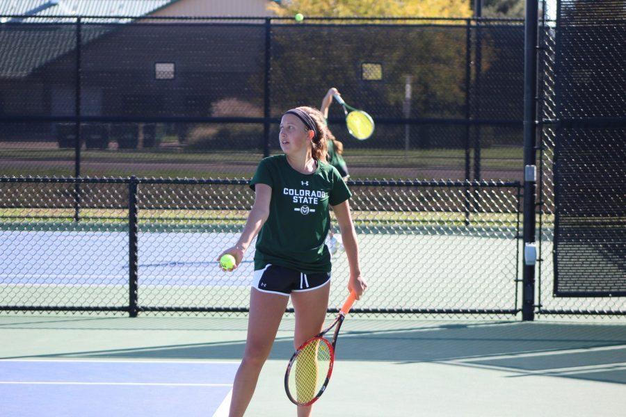 Junior, Emily Kolbow prepares to serve to a South Dakota opponent during her singles match at the Jon Messick Invitational on Oct 8. (Joshua Contreras | Collegian)