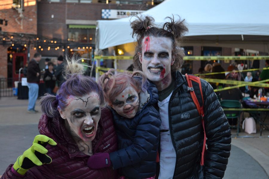 A family dressed as zombies attends Zombie Crawl 2017.  All proceeds from the event go towards the Turning Point Center for Youth and Family Development. (Matt Tackett | Collegian)