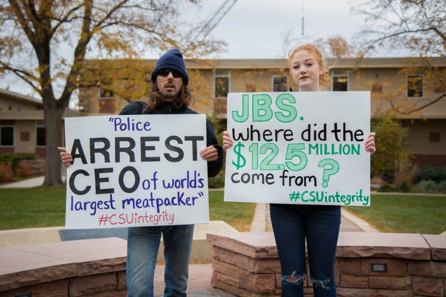 Lief Youngs, a CSU alumn, and Kendal Sonovick, a senior studying communications, protest the new animal science building on the Momfort Quad. (Julia Trowbridge | Collegian)