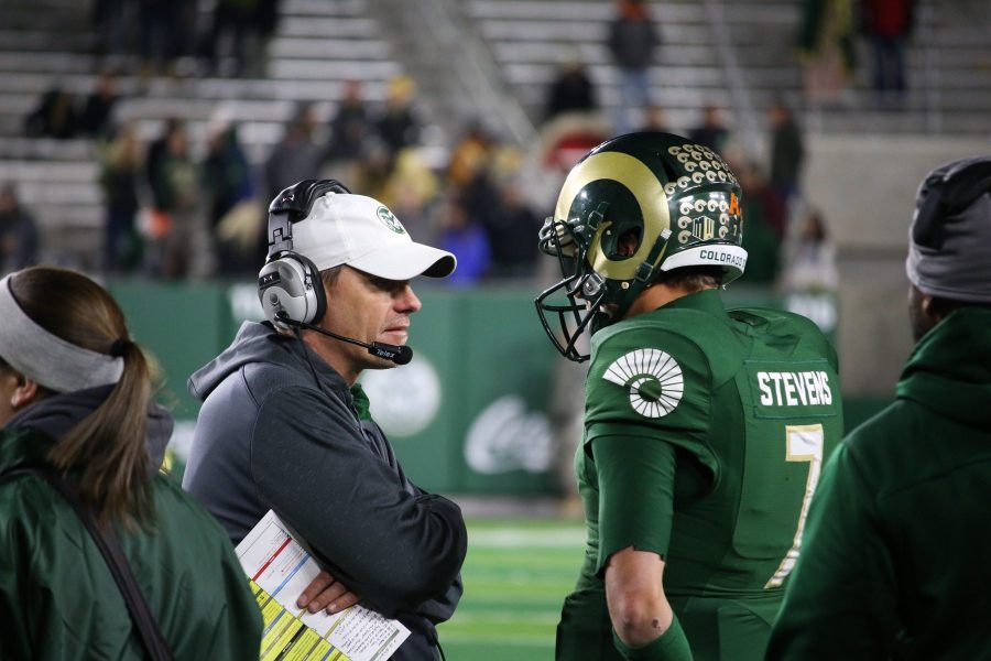Head coach Mike Bobo speaks with quarterback Nick Stevens during a 44-22 victory against the University of Nevada on October 14, 2017. (Jack Starkebaum)