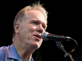 Loudon Wainwright III sings into a microphone