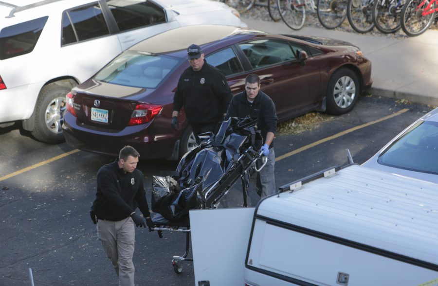 Fort Collins police remove a body from the scene of a fatal shooting Thursday morning. The suspected homicide occurred early that morning at 720 City Park west of CSU's main campus. (Davis Bonner | Collegian) 