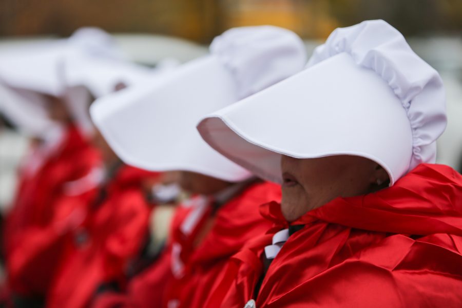 Protestors dressed as handmaids gather outside the Denver Marriott Tech Center where Vice President Mike Pence is to give a speech at a Republican Party fundraiser. The costumes are in reference to the popular television show Handmaids Tale that describes a world in which women are considered property. (Davis Bonner | Collegian)