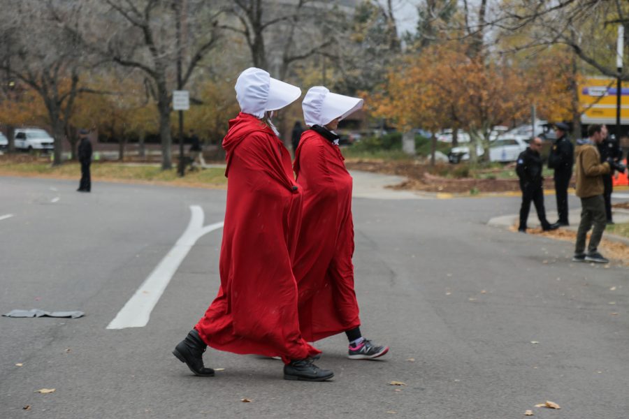 Protestors dressed as handmaids gather outside the Denver Marriott Tech Center where Vice President Mike Pence is to give a speech at a Republican Party fundraiser. The costumes are in reference to the popular television show Handmaids Tale that describes a world in which women are considered property. (Davis Bonner | Collegian)