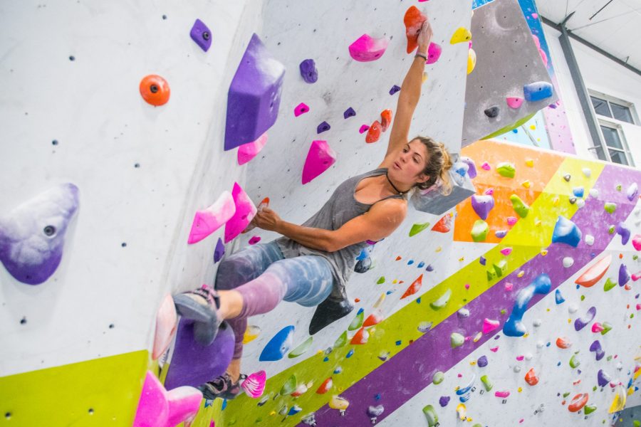 Dani Motaei, a CSU Rock Climbing competitor, reaches out for her footing. (Michael Berg | Collegian)