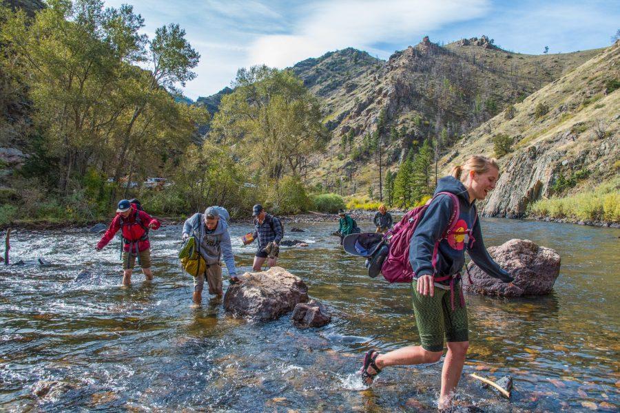 The CSU Outdoor Club crosses the Poudre River to go climbing at The Palace. (Michael Berg | Collegian)