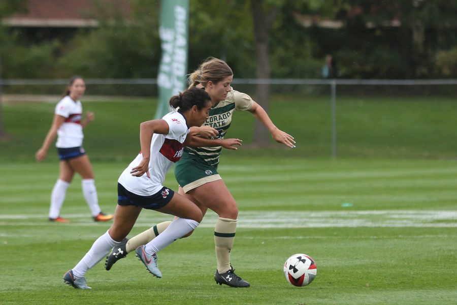 Midfielder Caeley Lordemann battles with a Fresno State player for possession of the ball during the first half of action on Oct 1. (Elliott Jerge | Collegian)