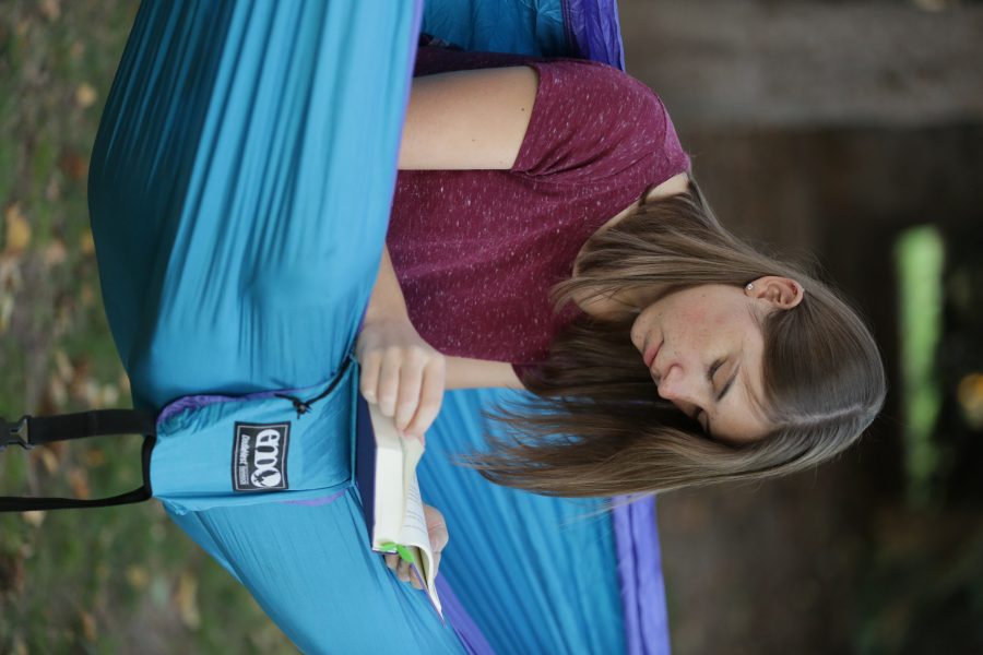 Bailey Richards, a first-year student at Colorado State University, reads while sitting in her hammock near the Lagoon on October 18, 2017. (Forrest Czarnecki | The Collegian)